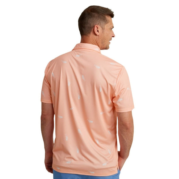 back view of a man wearing a huk fishing mens pursuit polo in fresh bones peach nectar on a white background