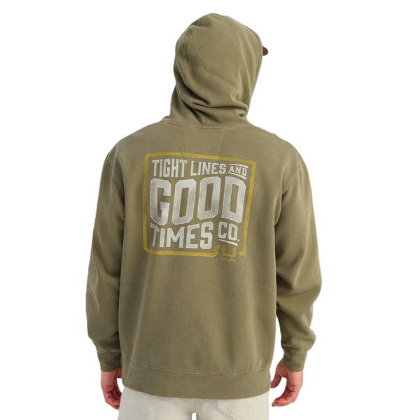 Person wearing a moss green Huk TighLine hoody with graphic on the back, over a white background.