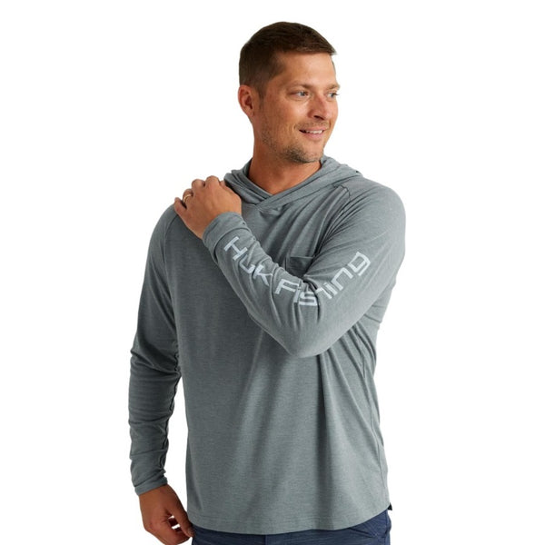 front view of a man wearing a night owl grey huk fishing men's waypoint  performance sun hoody on a white background