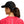Person wearing the Huk Women's Pony Tail Hat showing the back designed to accommodate ponytails on a white background.