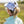 Person wearing the gray camouflage Huk Women's Pony Tail Hat showing the back designed to accommodate ponytails on a blurred background