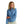 front view of a woman wearing a light blue huk fishing womens tide point button down long sleeve shirt and khaki pants on a white background