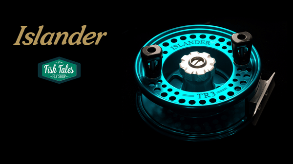A close-up studio shot of a Limited Edition Teal Islander TR3 Trolling Reel on a black background, with the gold Islander logo and green and white fish tales logo adjacent.