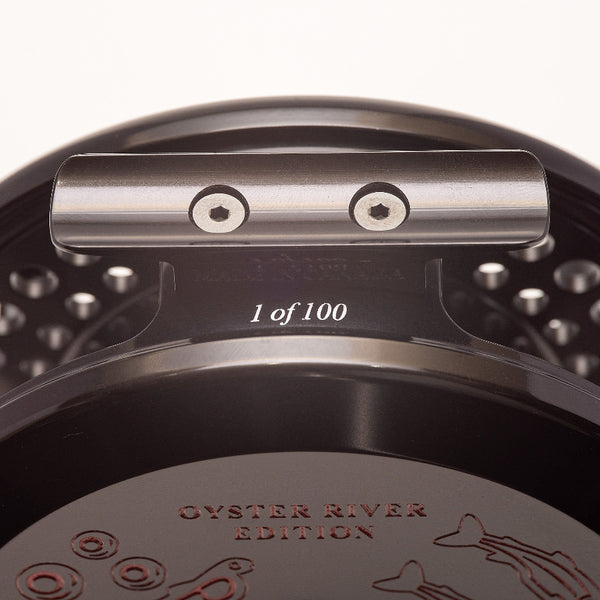 Close-up of an Islander TR3 Trolling Reel foot with '1 of 100' and 'Oyster River Edition' text on a white background.