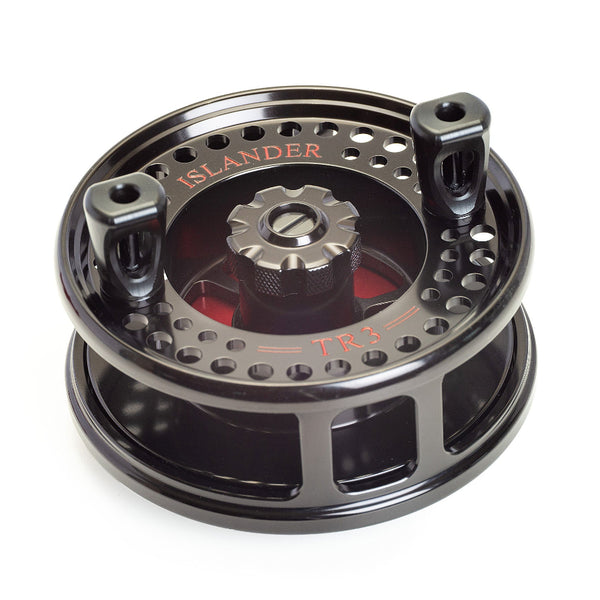 The Islander TR3 Trolling Reel - Oyster River Edition in black with red engraved artwork showing spool handle, on a white background.