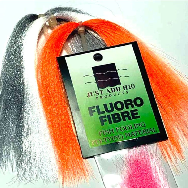 A group of Just Add H2O Fluoro Fiber fly tying material in a variety of colors on a white background.