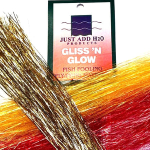 Several colors of Just Add H2O Gliss 'n Glow fly-tying flash material with packaging on a white background.
