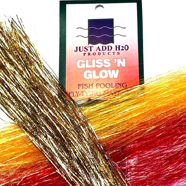 Several colors of Just Add H2O Gliss 'n Glow fly-tying flash material with packaging on a white background.