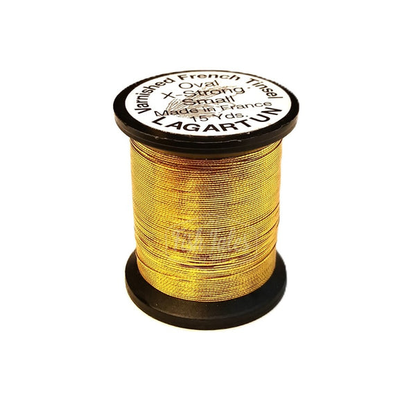 a single spool of gold lagartun oval metal fly tying tinsel on a white background 