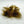 A bundle of brown mohair dubbing on a white background, used for crafting fishing flies.
