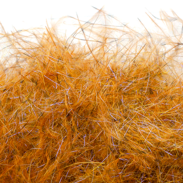 A close-up image of Senyo's Dirty Bird Dubbing, in dog puke gold color showcasing a mix of marabou and synthetic fibers with hints of flash.