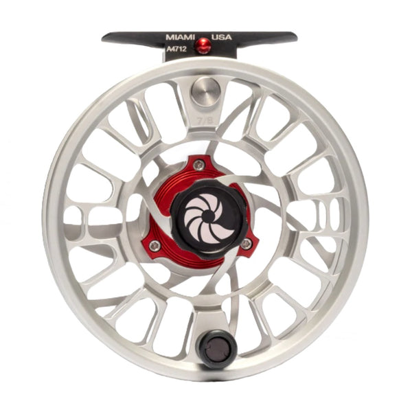 A Nautilus GTS Fly Reel with a silver  frame and black and red accents against a white background. 