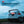 White car with the Nebo Bando 1k work light attached to the back as an emergency light, set against a blue sky.