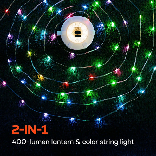 Colorful string lights of the Nebo luna 400 plus lantern on a dark grassy background.