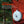 Nebo Luna 400 plus lantern attached to an orange backpack with a forest background.