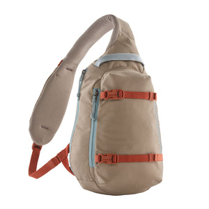 A seabird grey Patagonia Atom Sling 8L with adjustable shoulder strap and multiple compartments, designed for close-fitting comfort and minimal organization on a white background.