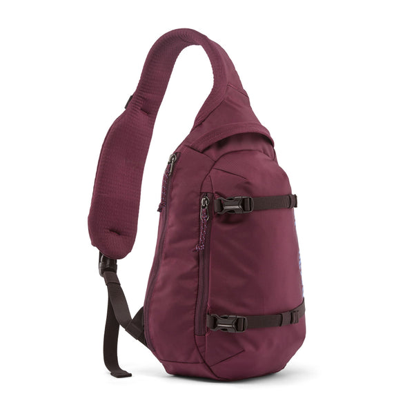 A berry fig Patagonia Atom Sling 8L with adjustable shoulder strap and multiple compartments, designed for close-fitting comfort on a white background.