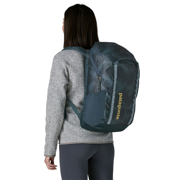 A person wearing the Patagonia Black Hole Backpack 32-Liter in sastrugi: summit blue shown from the back on a white background.