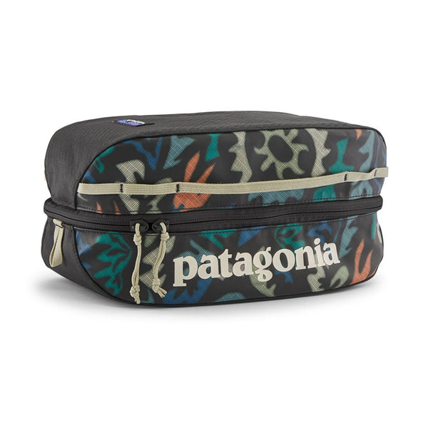 Patagonia Black Hole Cube 6-Liter with colorful kaleido black pattern and white patagonia logo, on a white background.