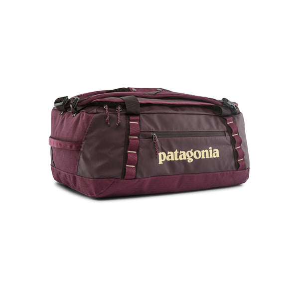 A Berry Fig 40-Liter Patagonia Black Hole Duffel Bag showing side logo and pocket with yellow accents, on a white background.
