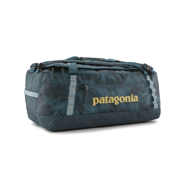 A Sastrugi Summit Blue 55-Liter Patagonia Black Hole Duffel Bag showing side logo and pocket with yellow accents, on a white background.