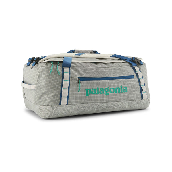 Birch White 55-Liter Patagonia Black Hole Duffel Bag showing side logo and pocket with blue accents, on a white background.