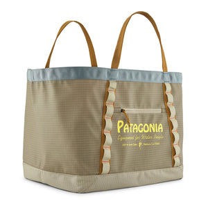 A 61L weathered stone Patagonia Black Hole Gear Tote with tan handles and the Patagonia Water People banner on the front pocket, on a white background.