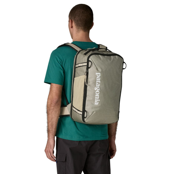 Person wearing the weathered stone Patagonia Black Hole Mini MLC Backpack 30L on a white background.