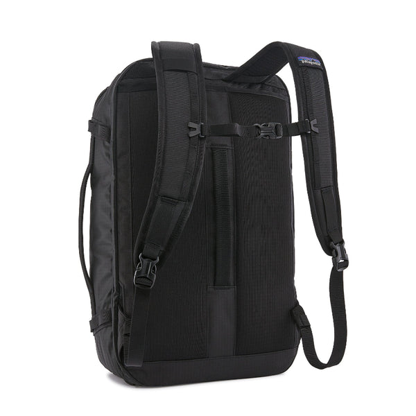Back view of the black Patagonia Black Hole Mini MLC Backpack 30L showing the waist strap tucked away on a white background.