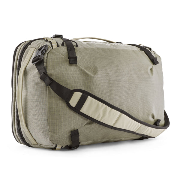 Side view of the weathered stone Patagonia Black Hole MLC Briefcase Backpack 45L on a white background.