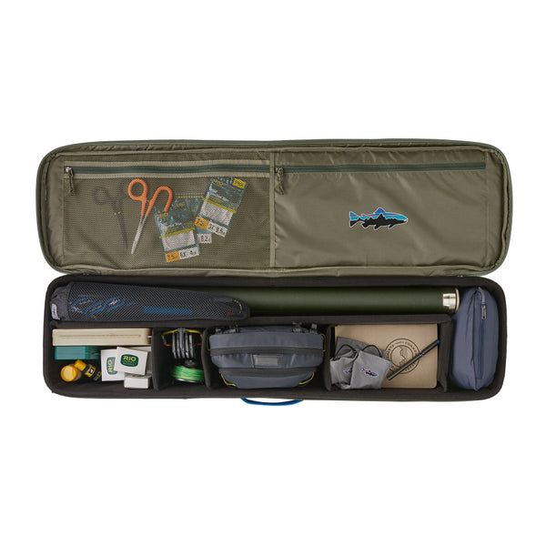 A basin green Patagonia Black Hole Fly Fishing Rod Case open showing adjustable compartments full of accessories (not included) and a visible Fitz Roy Trout brand logo on upper zippered pockets, on a white background.