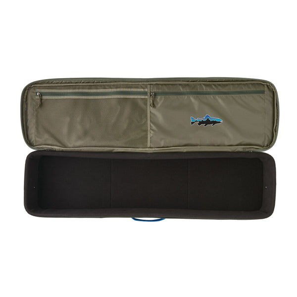 A basin green Patagonia Black Hole Fly Fishing Rod Case open showing an empty interior compartment and a visible Fitz Roy Trout brand logo on upper zippered pockets, on a white background.
