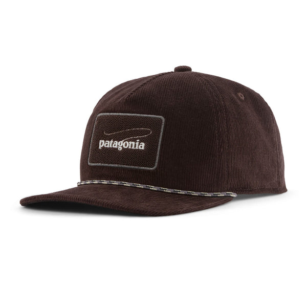 A Patagonia Fly Catcher Trucker Hat featuring a den brown corduroy front panel, brim, and back panels, and a trout shaped logo patch on the front, on a white background.