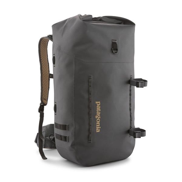 Forge grey Patagonia Guidewater Rolltop Backpack showing front with tan Patagonia logo and removable gear straps on a white background.