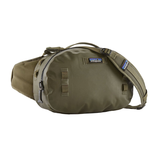 Front view of the Patagonia Guidewater Waterproof Fishing Hip Pack in Basin Green with blue accents on a white background.