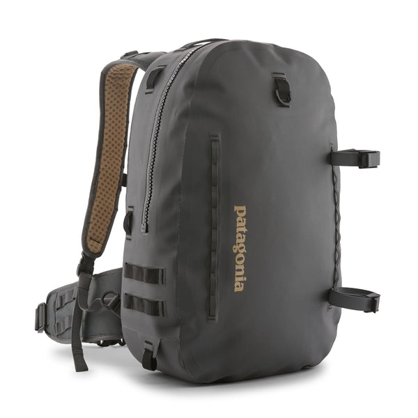 Forge grey 25-Liter Patagonia Guidewater Waterproof Backpack showing front with tan Patagonia logo and removable gear straps on a white background.
