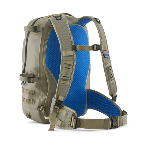 River Rock Green 25-Liter Patagonia Guidewater Waterproof Backpack showing back with blue mesh panel and stowable waist straps on a white background.