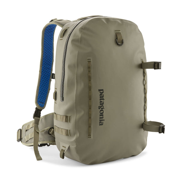 River Rock Green 25-Liter Patagonia Guidewater Waterproof Backpack showing front with Patagonia logo and removable gear straps on a white background.
