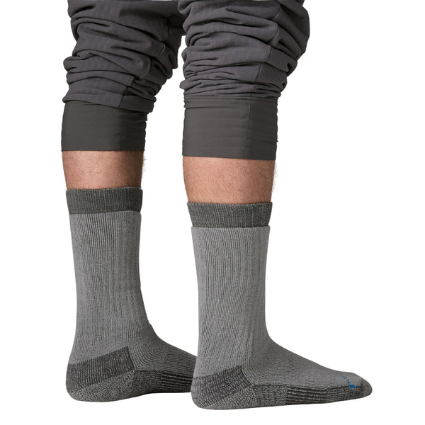 Person wearing a pair of grey Patagonia Heavyweight Merino Wool-Blend Knee Socks on a white background.
