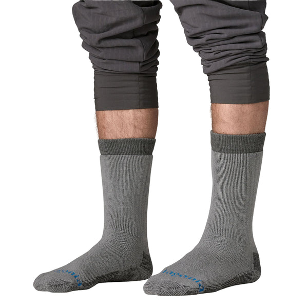 Person wearing a pair of grey Patagonia Heavyweight Merino Wool-Blend Knee Socks on a white background.