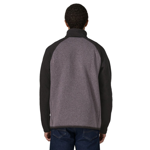 Person wearing jeans and the May grey and black raglan sleeve Patagonia Men's Better Sweater 1/4 Zip Pullover, shown from the back against a white background.