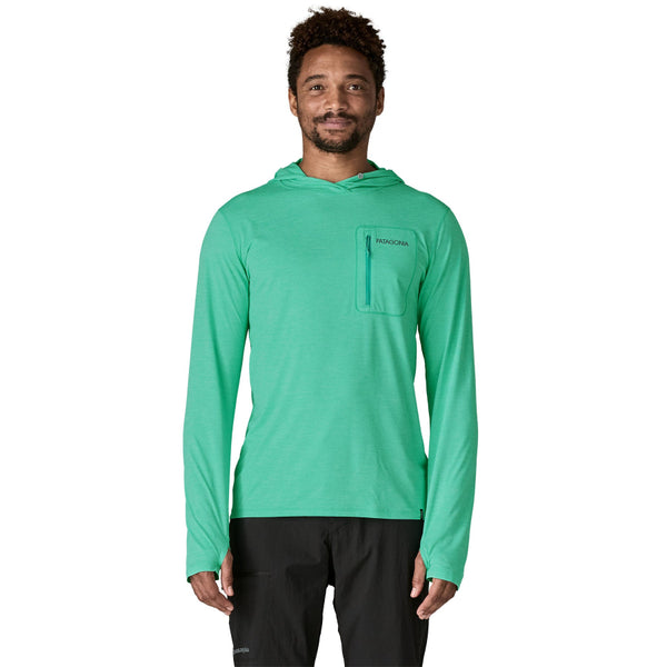 Person wearing the aqua stone and teal x-dye color  Patagonia Men's Capilene Cool Sun Hoody Peak Visions with small logo and pocket on front, on a white background.