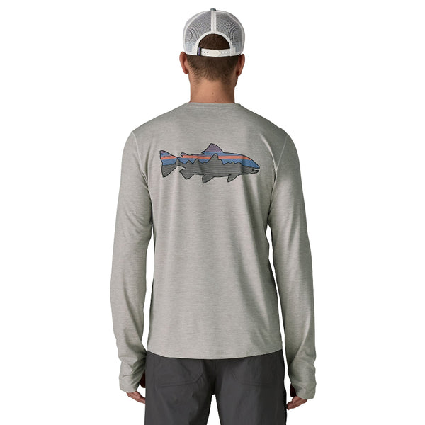 Person wearing a grey Patagonia Men's Capilene Cool Sun Shirt with a Fitz Roy Trout design on the back against a white background.