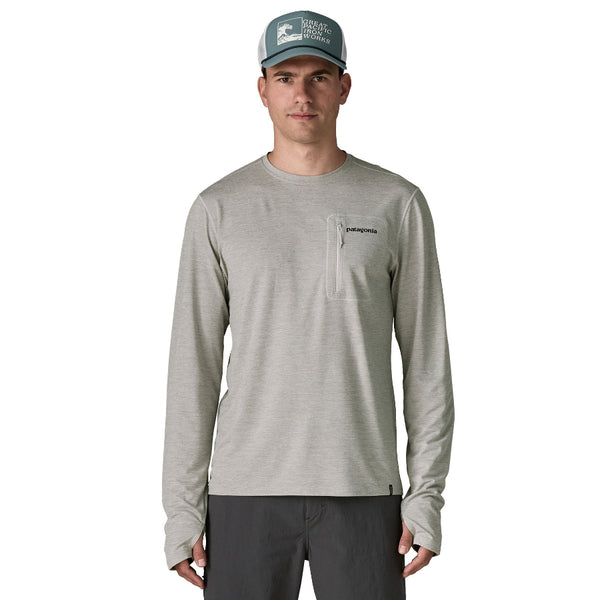 Person wearing a grey Patagonia Men's Capilene Cool Sun Shirt Fitz Roy Trout with logo and pocket on the front design on the back against a white background.