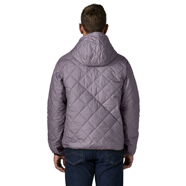 Person wearing the May Grey Patagonia Men's Diamond Quilted Bomber Hoody and jeans, showing the hood and the quilting at the back, on a white background.
