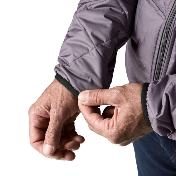 Close up of a person wearing the May Grey Patagonia Men's Diamond Quilted Bomber Hoody and showing the cuff details, on a white background.