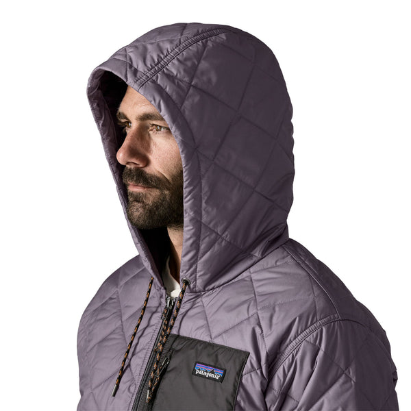 Close up of a person wearing the May Grey Patagonia Men's Diamond Quilted Bomber Hoody showing the hood details, on a white background.