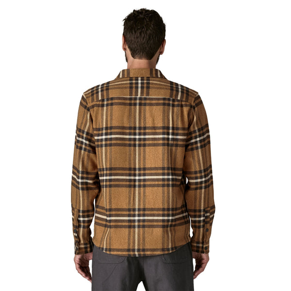 Man wearing Deer Brown plaid Patagonia Men's Fjord Flannel Long Sleeved Shirt on a white background.