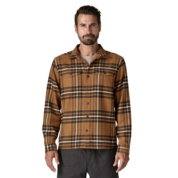 Man wearing Deer Brown plaid Patagonia Men's Fjord Flannel Long Sleeved Shirt on a white background.