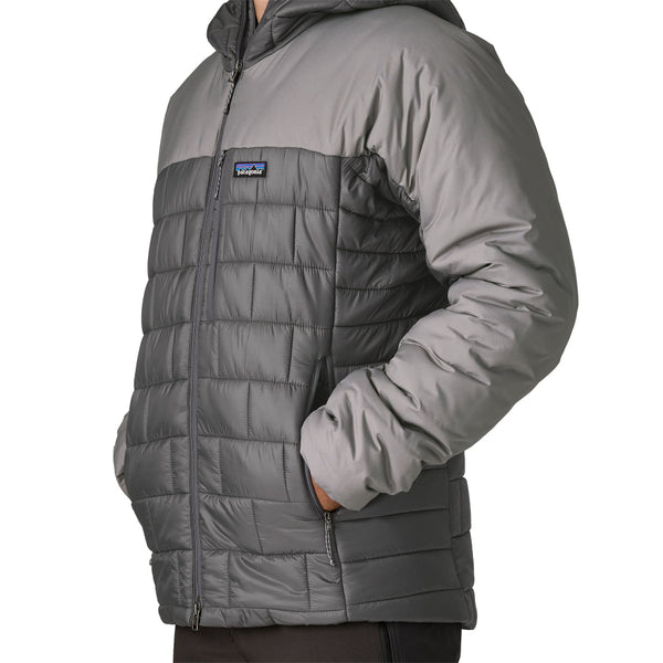 Man wearing the new for 2025 forge grey Patagonia Men's Hi-Loft Nano Puff Hoody showing pocket details on a white background.